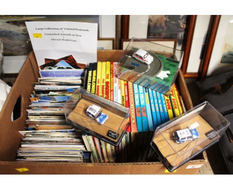 Box of unused postcards, children's annuals and die cast model cars