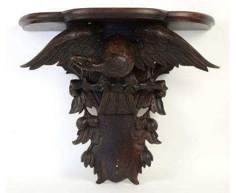 Mahogany wall bracket with eagle on a perch amongst fruiting branches, h64cm 