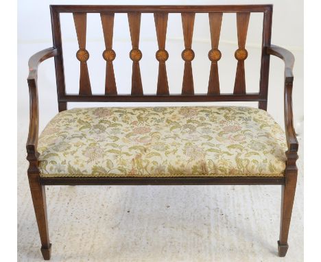 Early 20th century two seater settee with shell patera to splat back, having floral upholstered seat on tapering legs and spa