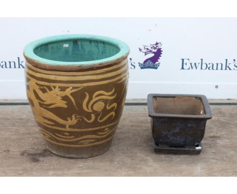 Large Chinese planter decorated with dragons chasing the flaming pearl on a brown ground within Greek Key border, having cela