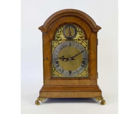 Early 20th century walnut cased bracket clock, the arched dial with silvered chapter ring with Roman and Arabic numerals, cha