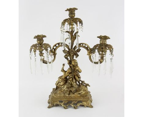 Early 20th century gilt metal figural three light candelabra with scroll arms, a young man and woman fishing, with glass hang