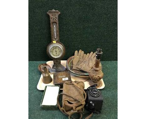A tray of carved oak barometer, carved table lamp, wooden bowls, camera, leather gloves, wooden cigarette box etc