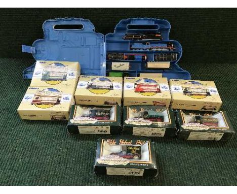 A tray of five boxed Corgi trams, four Eddie Stobbart vehicles and a Thomas the Tank Engine case containing die-cast trains