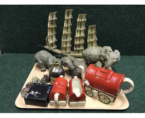 A tray of three piece English pottery wagon teapot, milk jug and basin, elephant figures, bone four masted ship, paperweights