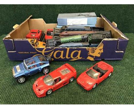 A box of assorted die cast sports cars, boxed Atlas small scale battleships, plastic trains on stands 