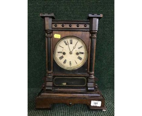 A 19th century German mantel clock in mahogany case (with pendulum and key)