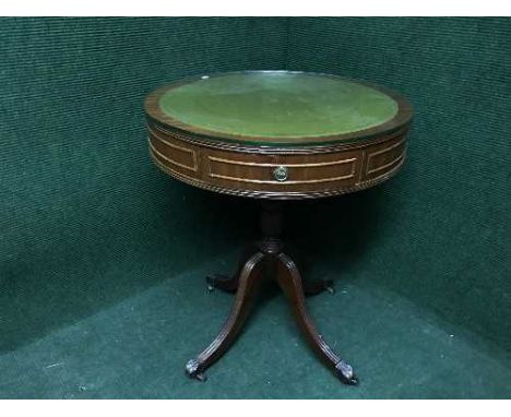 A circular yew wood drum table inset with green leather panel on four way support