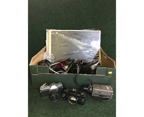 A box of cameras, Genaflex, Mamya, Panasonic CCTV camera, unframed black and white photographs