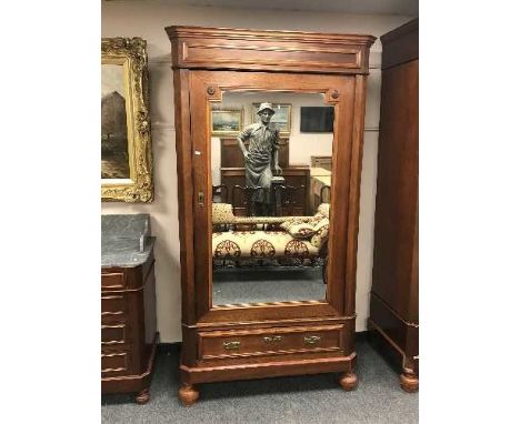 A late Victorian mahogany mirror door wardrobe