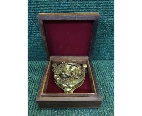 A brass compass / sun dial in a mahogany and brass inlaid box 