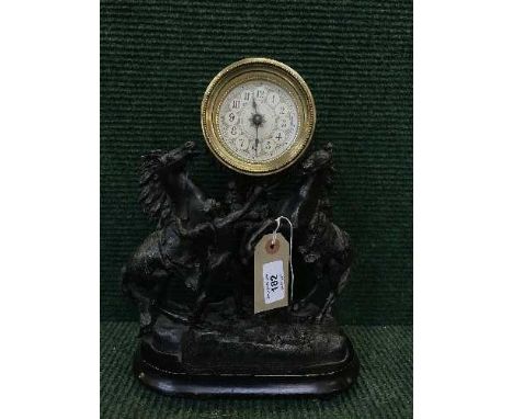 A late 19th century spelter mantel clock on wooden base 