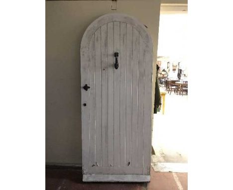 A pine arched door with metal fittings and door knocker with  key