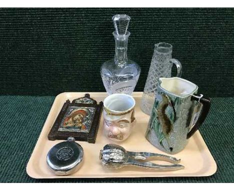 A tray of collectables including American Art Pottery jug by L Batlin and Son Inc, heavy crystal decanter, German nut cracker