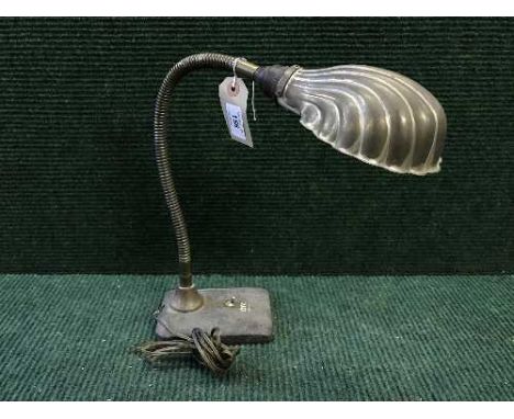 An early twentieth century angle poise lamp with shell shade