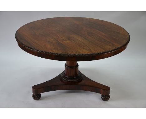 A Victorian rosewood breakfast table, the circular top with moulded edge, raised on a column to a tri-form platform base on r