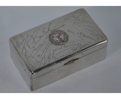 A Chinese silver cigarette box with cedar lining, mounted with enamel badge for the Shanghai Municipal Police and engraved wi