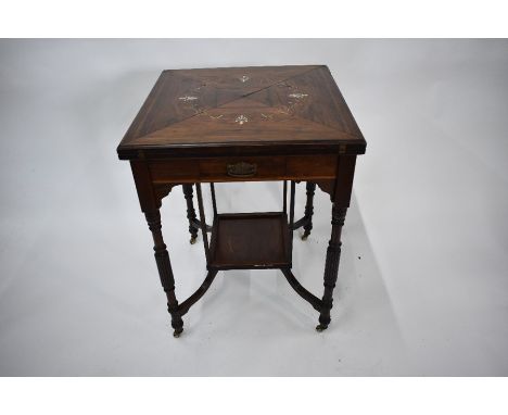 A Victorian inlaid rosewood envelope card table with frieze drawer, raised on turned part fluted legs united by an undertier,