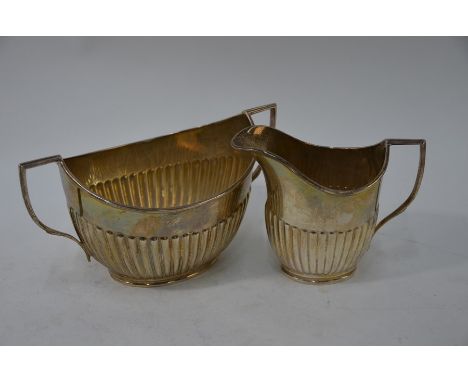 A heavy quality silver half-reeded milk and sugar pair of elliptical form, William Hutton &amp; Sons Ltd, Sheffield 1920, 12 