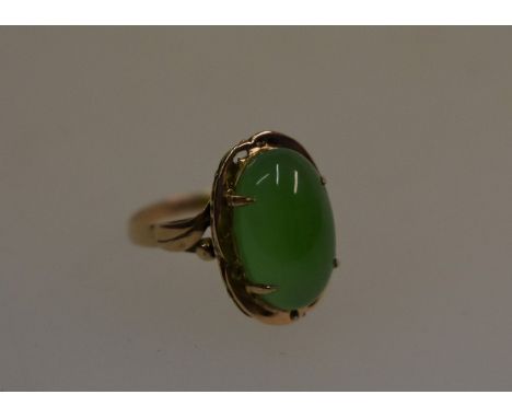 A yellow metal ring set with oval green hardstone, size M&nbsp;stone 15 mm x 8 mm, good overall condition, approx. 3g all-in