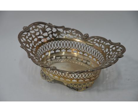 An Edwardian Sheraton revival pierced silver bonbon basket with cherub mask-set scrolling rim, W &amp; C Sissons, London 1901