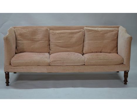 A late 19th/20th century three seat wing-back sofa in faded pink fabric, on turned legs, 204 cm long, 73 cm deep, 88 cm high