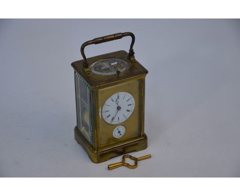A 19th century French brass carriage clock, repeat-striking on a coiled gong, also with alarm movement, the two enamel dials 