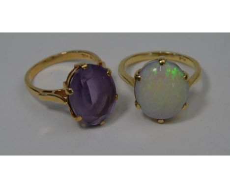 Two rings - one oval opal set 9ct yellow gold, size O, opal 1.5 x 1.3 cm and an oval claw set amethyst 9ct yellow gold, size 