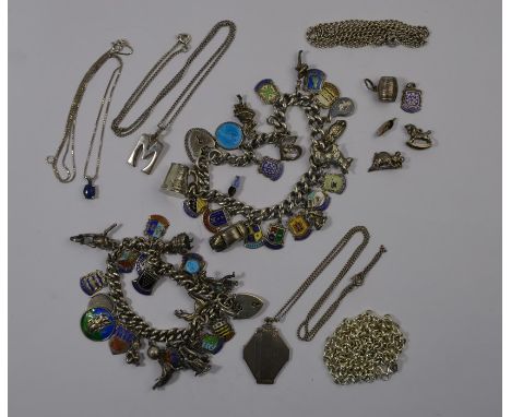 A collection of silver and white metal jewellery items including two charm bracelets, loose charms, chains and pendants etc a