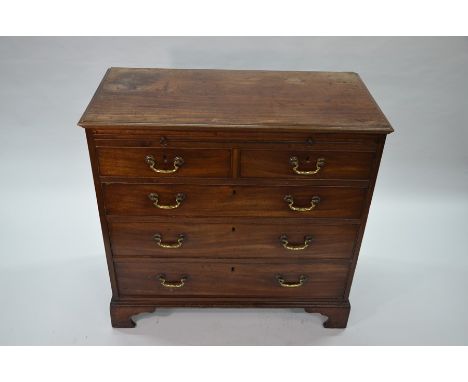 A George III mahogany chest of two short drawers over three long graduated drawers, beneath a full width baize lined slide, r