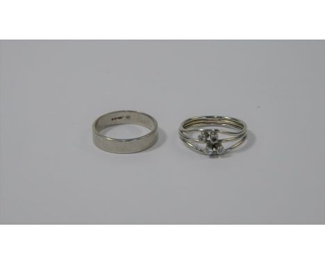 A flat-sided platinum wedding band, size K to/w a white metal three banded ring set with white stones, size J/K, approx 6.7g 