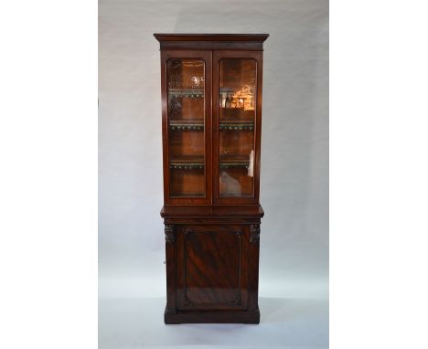 Victorian mahogany library bookcase of narrow form, the pair of glazed in cabinet doors enclosing adjustable shelves, over ar