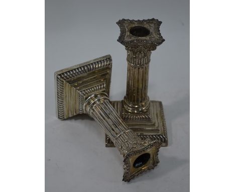 A pair of late Victorian loaded silver classical column candlesticks, Goldsmiths &amp; Silversmiths Co., London 1897, 14 cm h