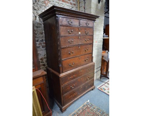 A Georgian provincial mahogany/walnut chest on chest, the dentil moulded cornice over ban arrangement of two short and seven 