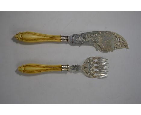 A Victorian pair of engraved and pierced silver fish servers with carved ivory handles, Joseph Rogers &amp; Sons, Sheffield 1