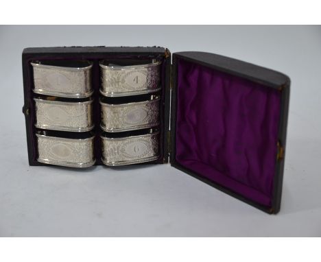 A Victorian cased set of six foliate-engraved silver napkin rings, numbered, Henry Atkin, Sheffield 1882, 5.5 ox (box f/r)