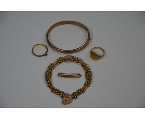 A 9ct rose gold gate link bracelet with padlock and chain attached; a 9ct rose gold half-hinged bangle, bar brooch, 9ct yello