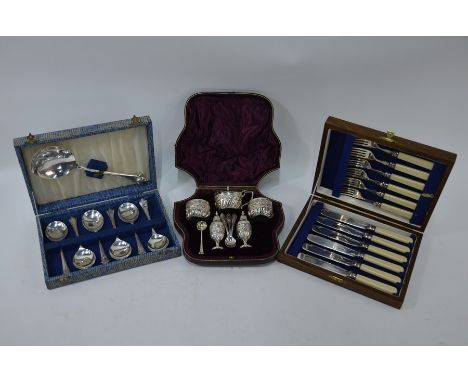 A Victorian cased silver five-piece condiment set with floral chased and writhen decoration, the pepperettes with loaded base