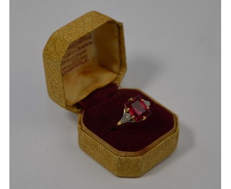 An Art Deco style ring, the claw set rectangular ruby with diamond set shoulders, 18ct and platinum set, size N, stone 1 x 0.