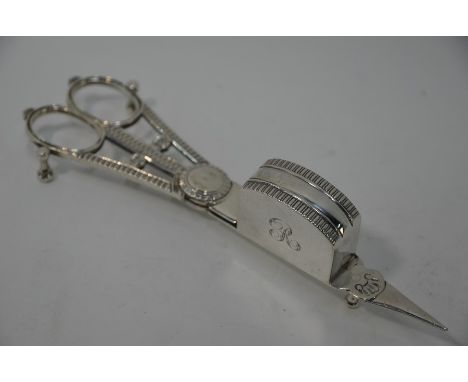 A pair of George III silver candle-snuffers with sprung scissor action and egg and dart edging with shell motifs, Wilkes &amp