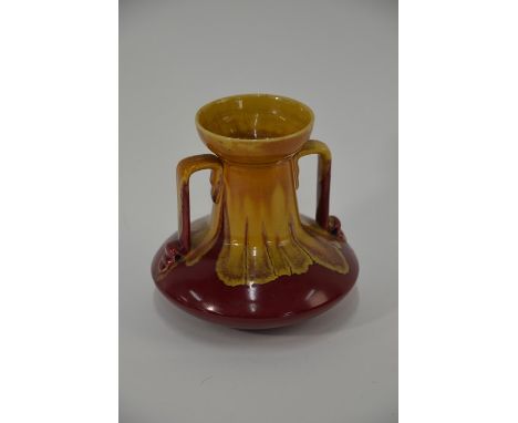 An Arts &amp; Crafts Linthorpe Pottery twin handle vase designed by Christopher Dresser, shape no. 957, decorated in a runnin