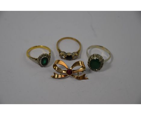 A three stone diamond and blue sapphire ring, 9ct yellow gold set size N/O; an emerald and diamond cluster ring 18ct yellow g