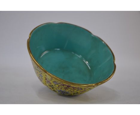 A Chinese famille rose floriform bowl with deep lobed sides and circular foot, decorated with shou symbols, bats and lotus sc