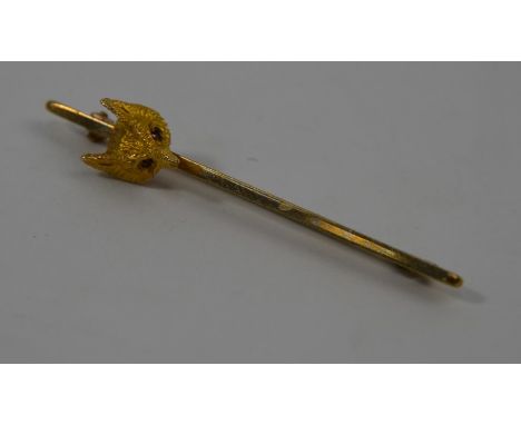 A 9ct yellow gold bar brooch with fox head terminal on knife-edge bar, cabochon ruby set eyes, 5 cm long, 3.8g all in