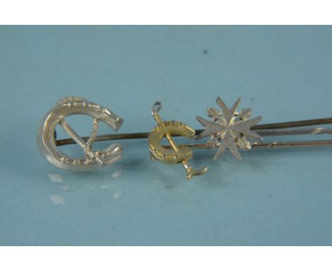 Three white and yellow metal stick pins, two of horse riding themes