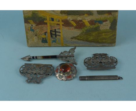 A silver nurses buckle with pierced decoration, a silver pencil holder, a white metal agate set arrow brooch and a white meta