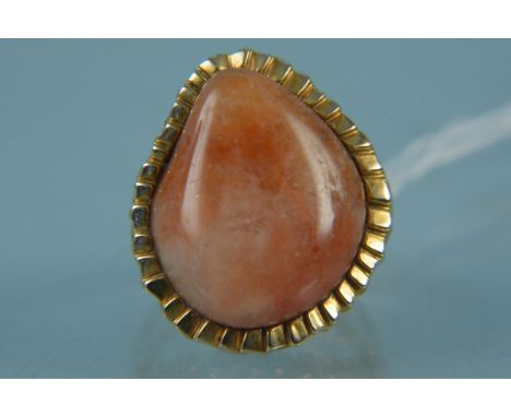 A 9ct gold abstract design ring set with orange hardstone, size K 1/2, weight approx 22g