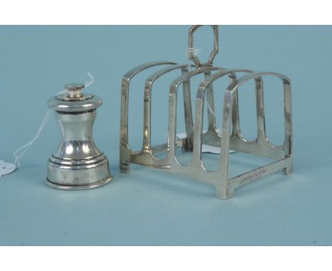 A silver toast rack plus a miniature silver pepper grinder