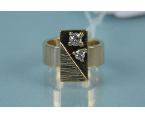 A 9ct gold ring with rectangular panel centre, bark engraved to one side and two diamonds set to the other, size K, weight ap