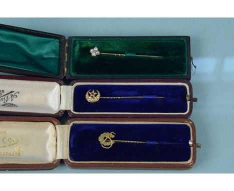 Three boxed stick pins, a 15ct gold seed pearl and ruby crescent moon and star, a yellow metal diamond and seed pearl and 9ct